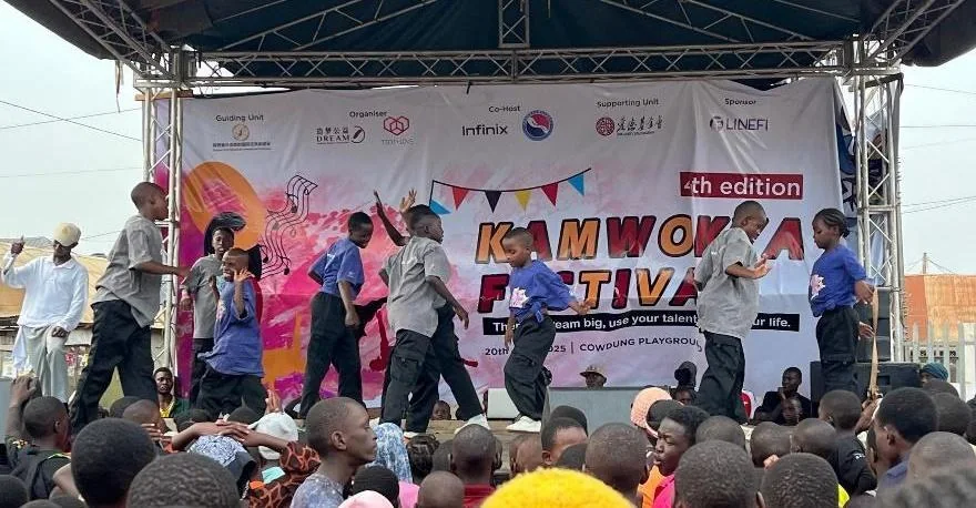 Dance teams performing on stage at the Kamwokya Community Carnival